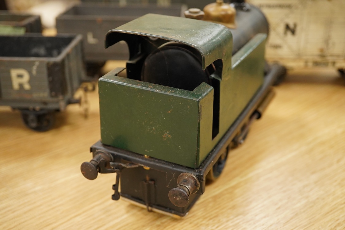 A Gauge One live steam 0-4-0T locomotive in the style of a Bowman model locomotive, with spirit fired with two simple outside oscillating cylinders, together with five LNWR and Midland Railway freight wagons, including a
